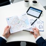 An international buyer preparing for the Canton Fair with a pavilion map, schedule, and product sketches.